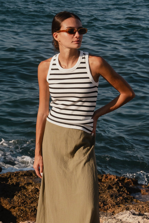 model wears a white black stripe singlet