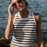 model wears a white black stripe singlet