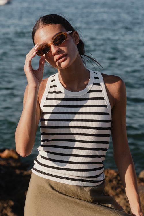 model wears a white black stripe singlet