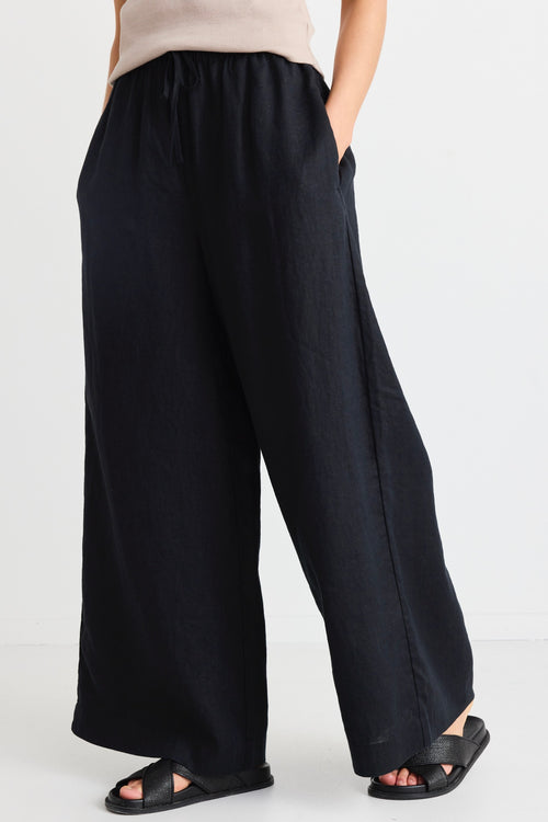 model wears black linen pants