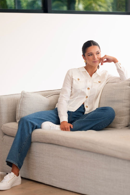 model wears a white linen jacket