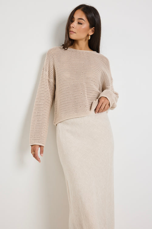 Model wears a crochet beige jumper