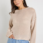 Model wears a crochet beige jumper