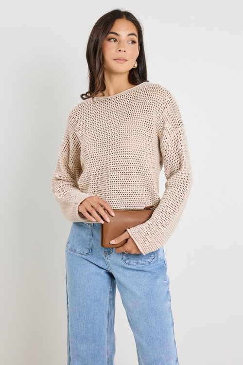 Model wears a crochet beige jumper