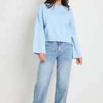 Model wears ice blue knit top