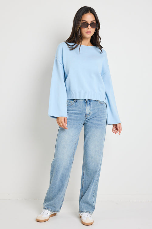 Model wears ice blue knit top