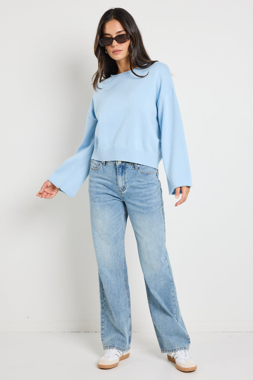 Model wears ice blue knit top