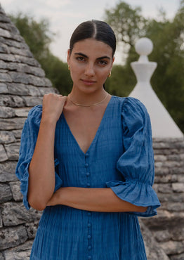 model wears a blue midi dress