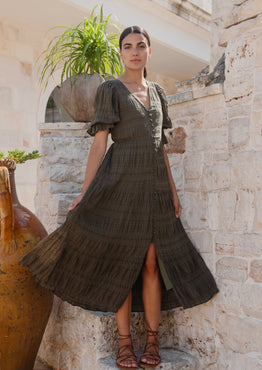 model wears a green midi dress