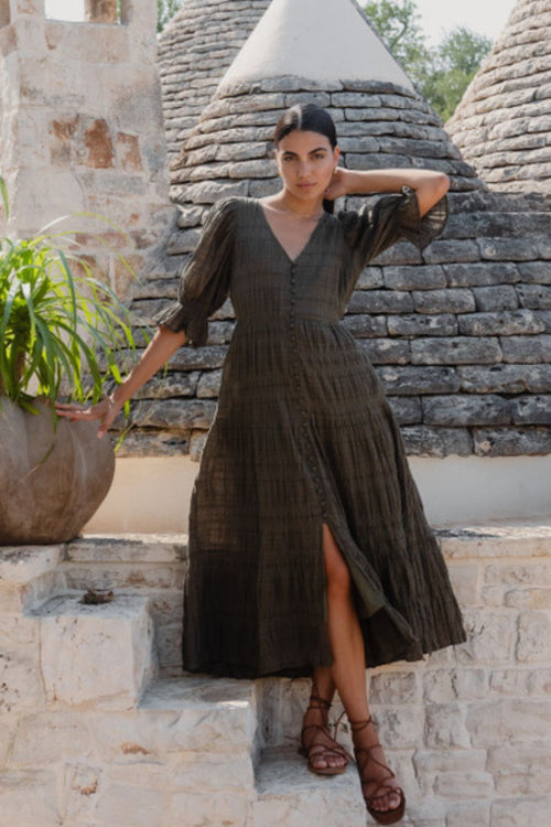 model wears a green midi dress