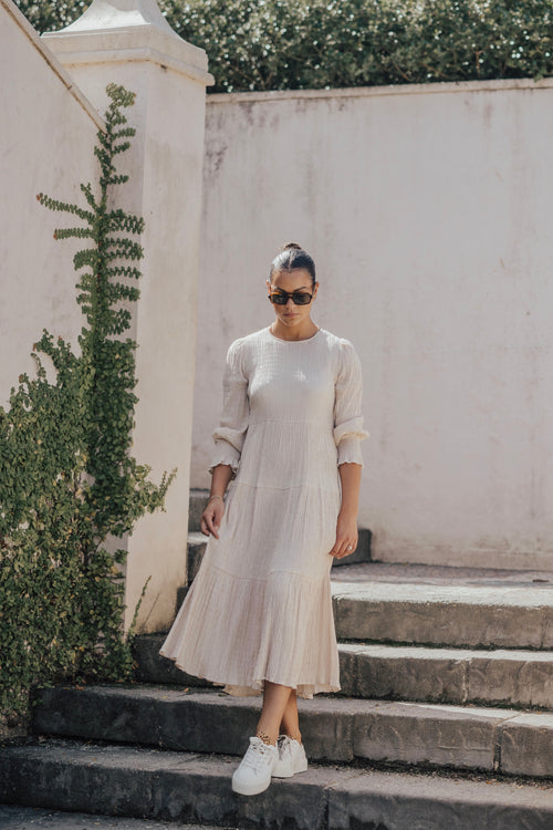 model wears a beige long sleeve maxi dress