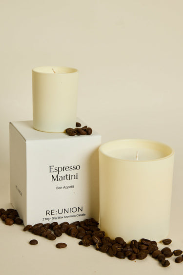 Candle labeled 'Espresso Martini' by Reunion with coffee beans on a beige background