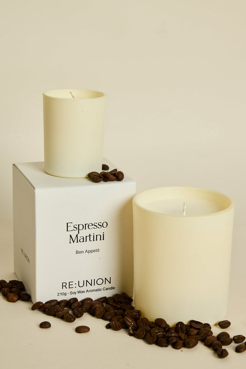 Candle labeled 'Espresso Martini' by Reunion with coffee beans on a beige background
