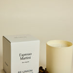 Candle labeled 'Espresso Martini' by RE:UNION with a box and coffee beans on a light background