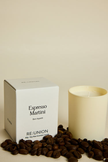 Candle labeled 'Espresso Martini' by RE:UNION with a box and coffee beans on a light background