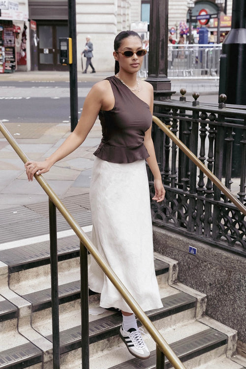 model wears a brown one shoulder top