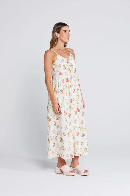 Woman wearing a floral cream long dress