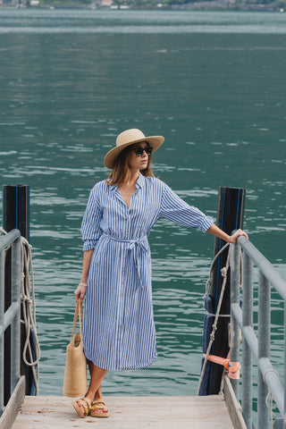 model wears a blue stripe shirt dress