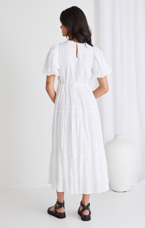 model wears a white maxi dress