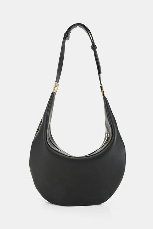 A black leather crescent-shaped shoulder bag with a single shoulder strap and gold-tone hardware, shown against a light gray background.