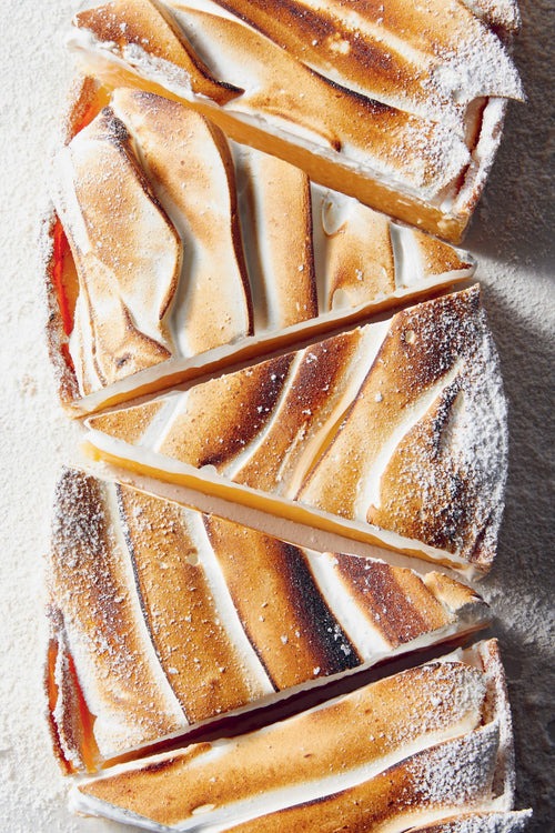 Baked good with caramel stripes on a white surface, accompanied by a table of contents on an orange background.