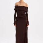 Woman wearing a brown off-shoulder gown on a white background