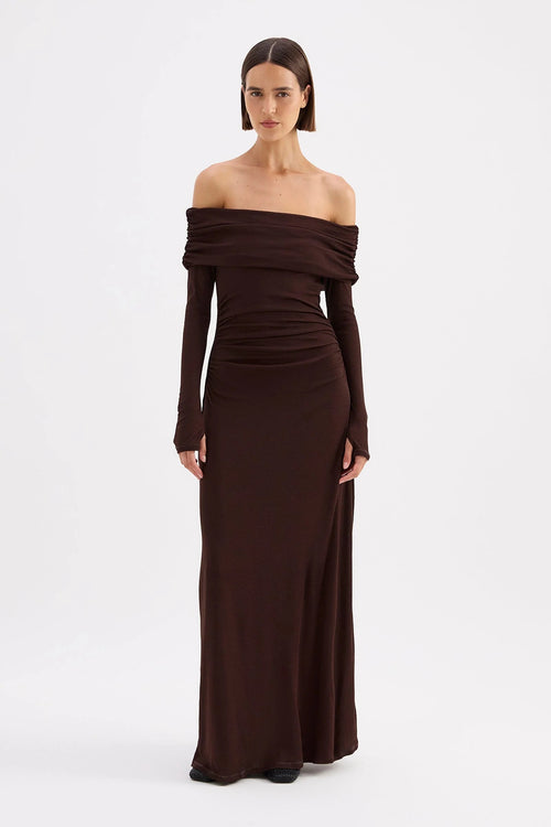 Woman wearing a brown off-shoulder gown on a white background