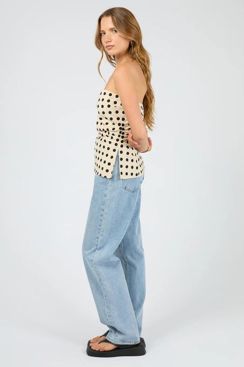 The Nieve Strapless Top worn with light blue denim. 