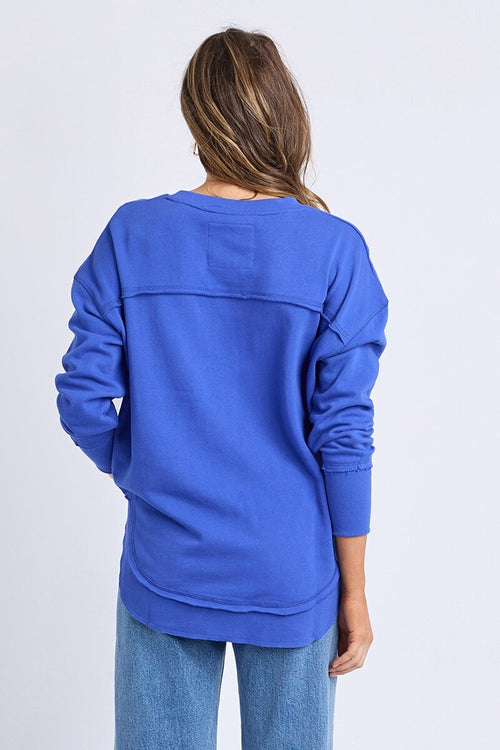 Women wearing blue crewneck and blue jeans