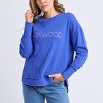 Women wearing blue crewneck and blue jeans