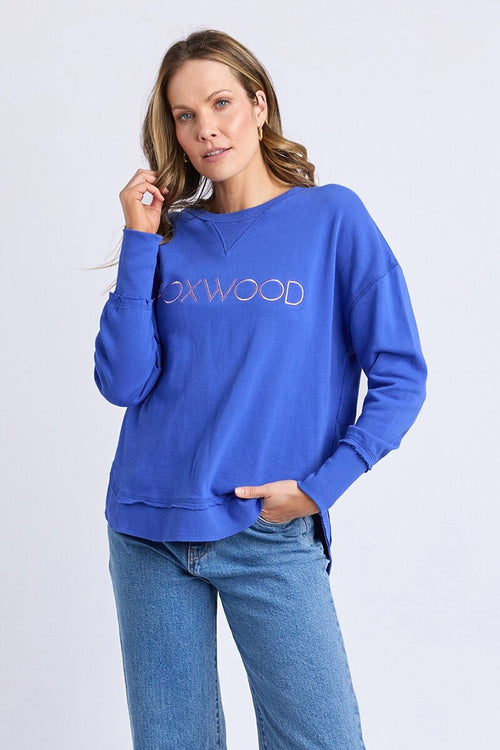 Women wearing blue crewneck and blue jeans