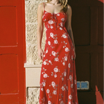Woman wears a red floral strappy maxi dress