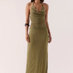 Woman wears a green maxi dress