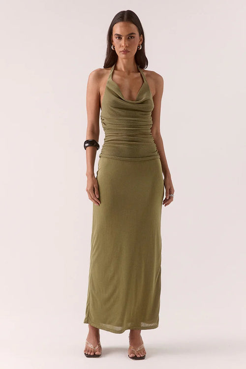 Woman wears a green maxi dress