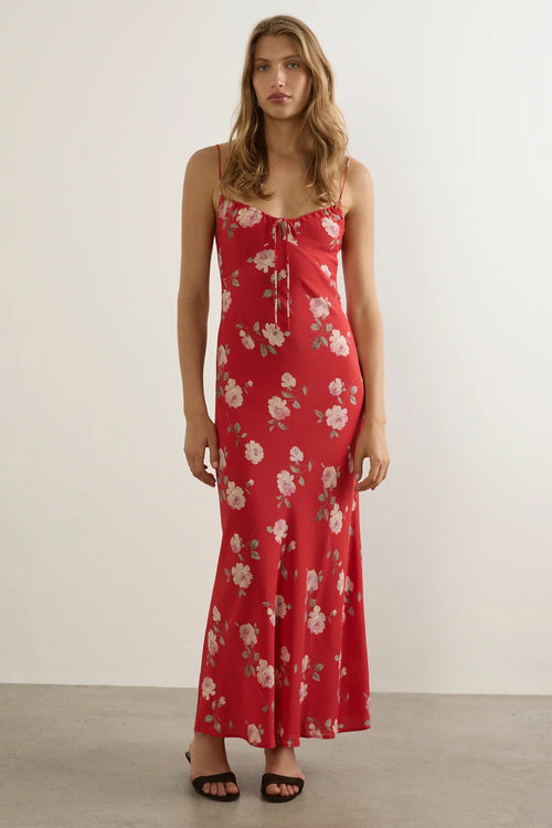 Woman wears a red floral strappy maxi dress