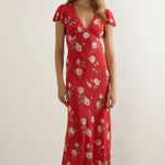Woman wears a red floral maxi dress