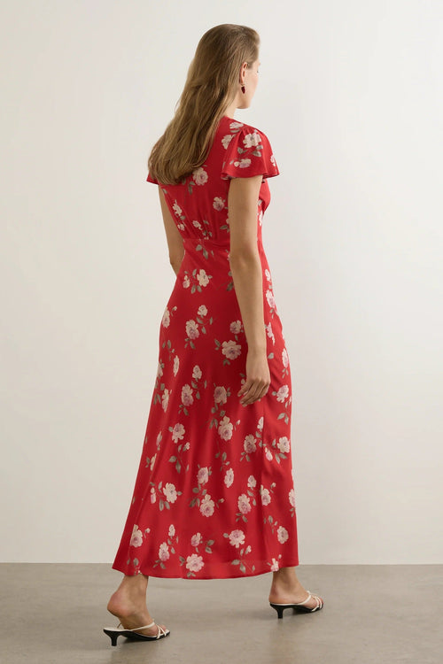 Woman wears a red floral maxi dress