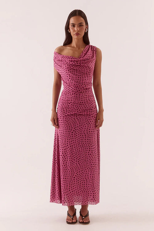 Woman wearing a pink polka dot dress on a white background