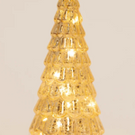 A small, textured gold Christmas tree light with warm white LED lights glowing inside, set against a plain light beige background.