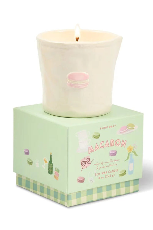 Candle in a decorative box with 'Macaron' branding on a white background