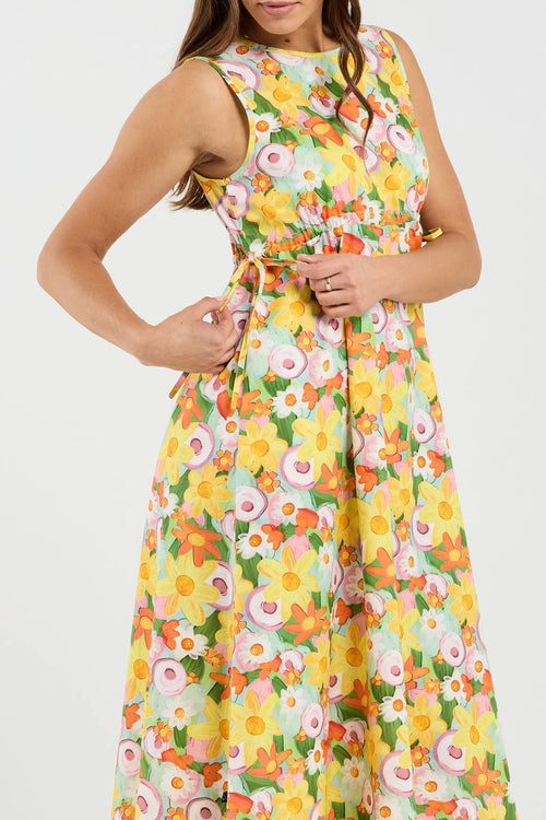 Woman wearing a colorful floral dress on a white background
