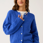 Woman wearing a blue cardigan on a white background
