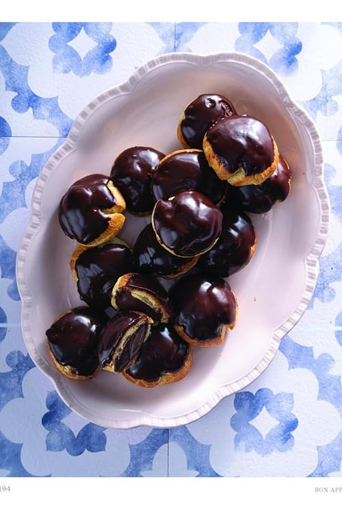 A recipe book page featuring a photograph of chocolate-covered pastry bites on a white plate, with the title 'ÉCLAIR BITES' and recipe text on the right page.