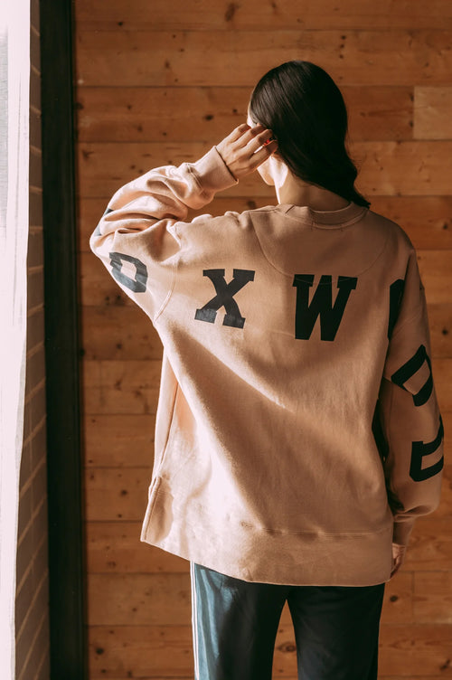 Model wears tan foxwood crewneck jumper