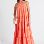 model in orange maxi dress