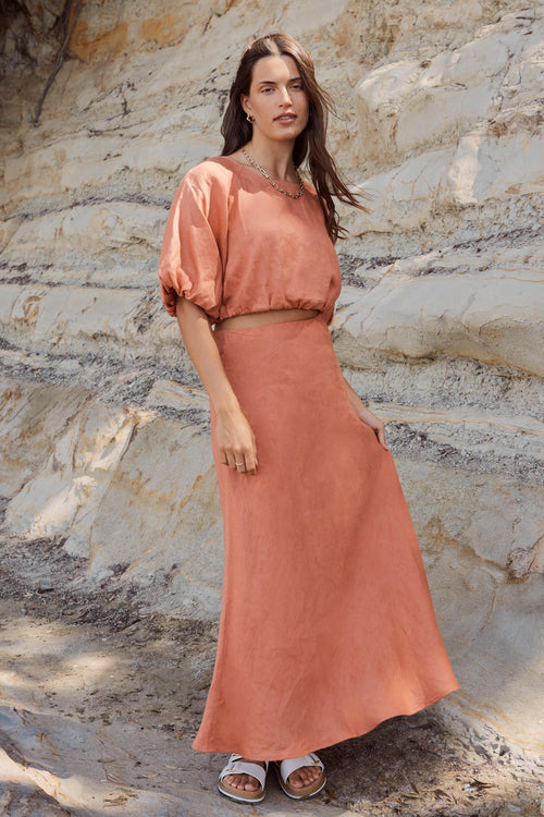 model wears a orange linen skirt