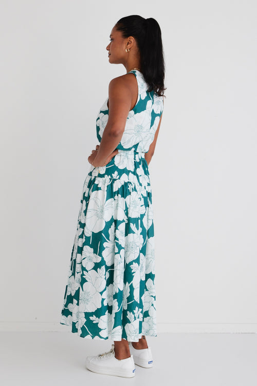 Model wears a green floral skirt and green floral top