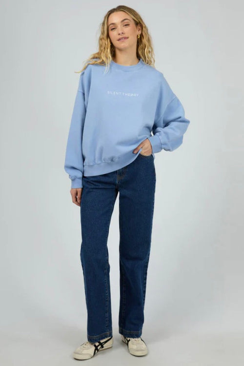 Model wears a light blue crewneck long sleeve jumper
