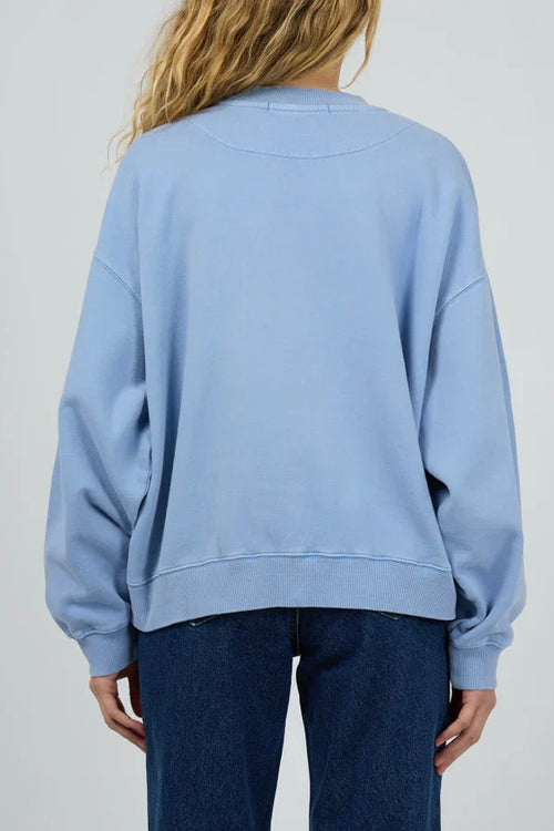 Model wears a light blue crewneck long sleeve jumper