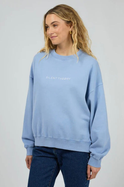 Model wears a light blue crewneck long sleeve jumper